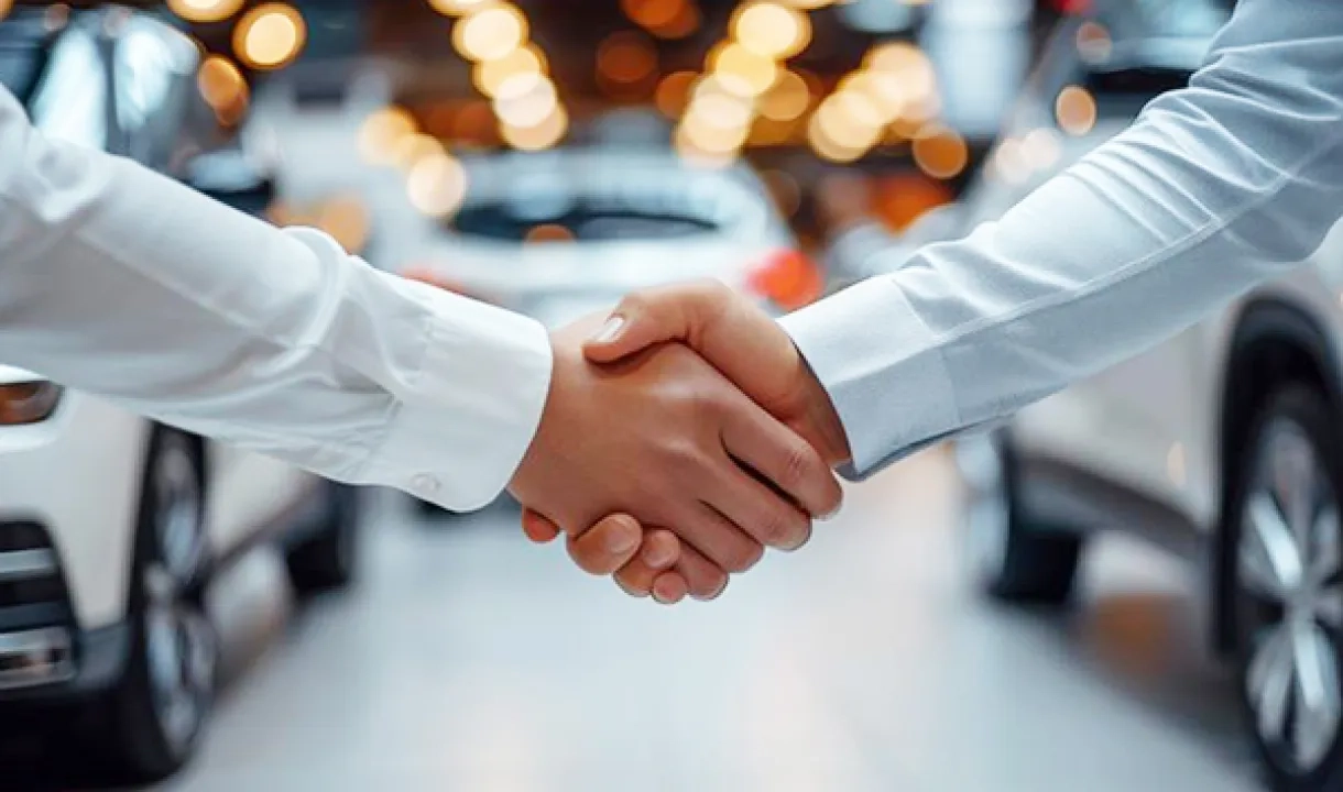 Push - two-individuals-shake-hands-car-dealership-signifying-successful-conclusion-car-purchase-blurred-vehicles-bright.jpg