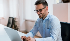 Image-happy-young-businessman-using-laptop-his-office-desk (2)